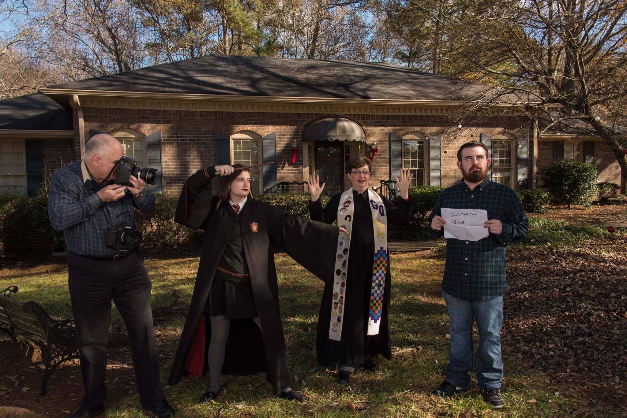 The front of our annual Christmas card this year featured our daughter in her Hogwarts robe casting a spell on her brother, while I, in my clerical robe and stole, held up my hands to stop her and Stanley documented the action with his camera. A totally silly photo. Taylor's sign reads, "I should have been adopted." since he is always shaking his head at our silly antics.