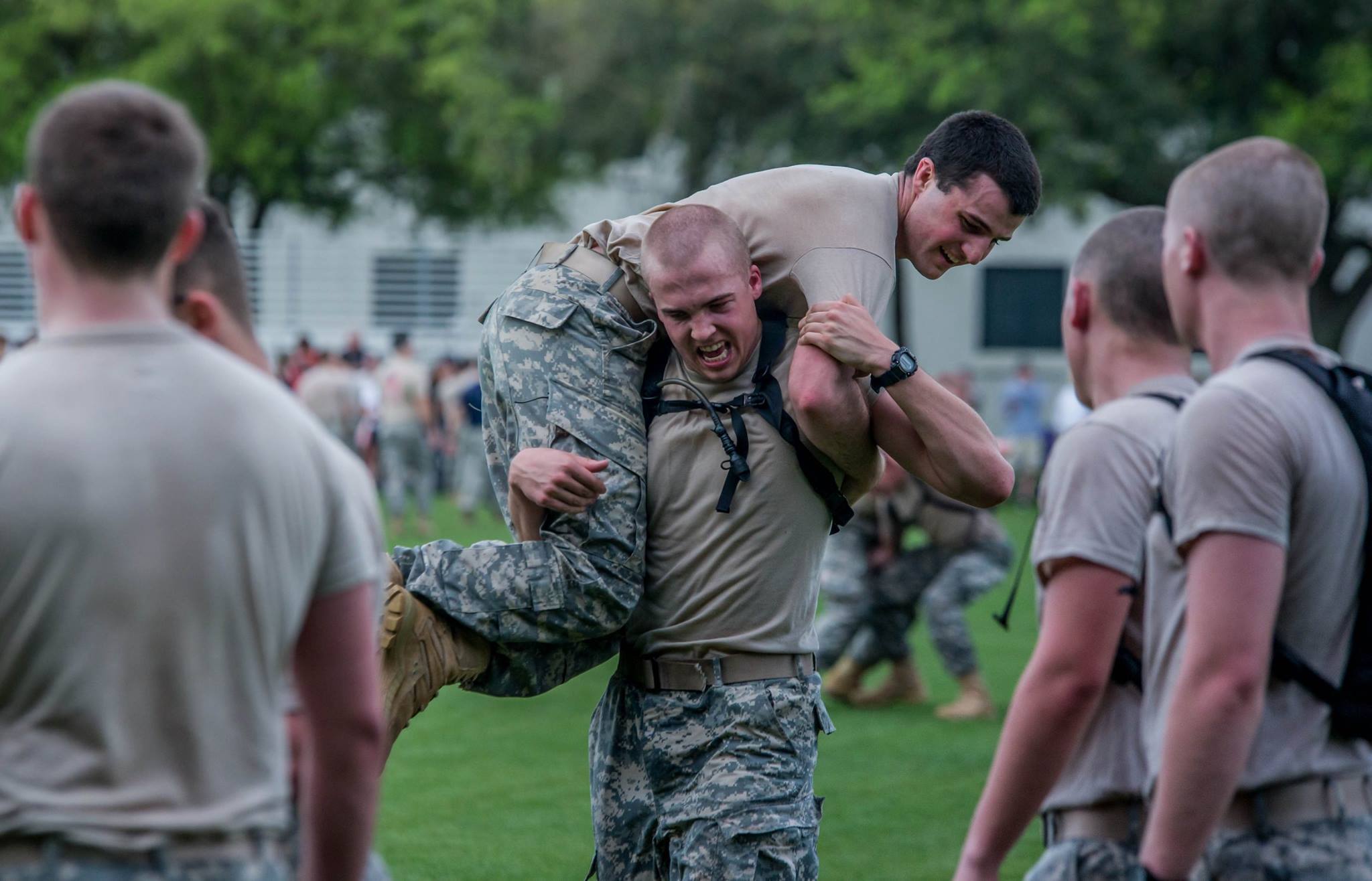 A 4th Class cadet carries and upperclass cadet at one of the stations during the "Gauntlet."