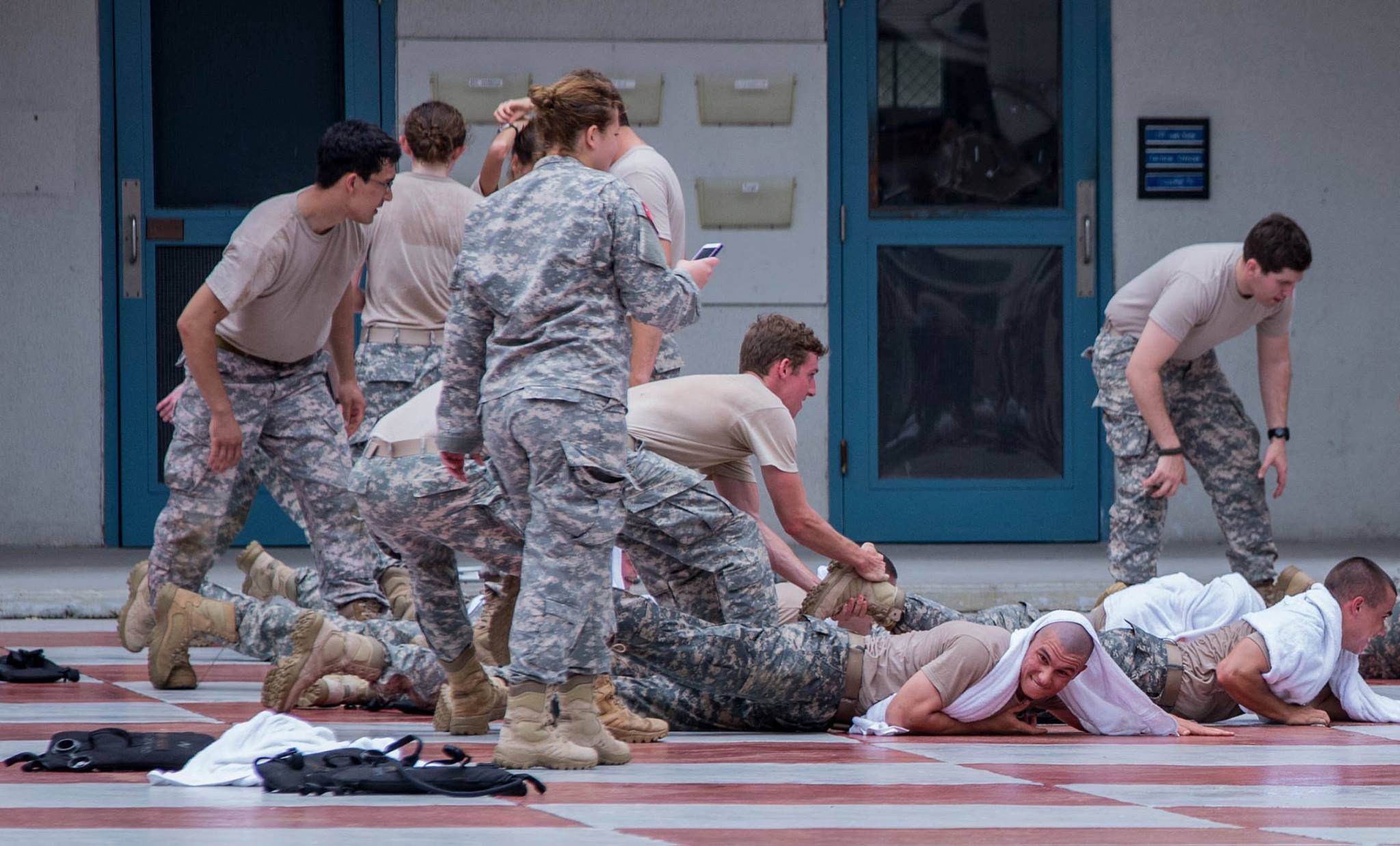 4 class cadets crawl toward the company guidon while upperclass cadet try to keep them from the guidon. photo by Stacy Carter Photography Studios